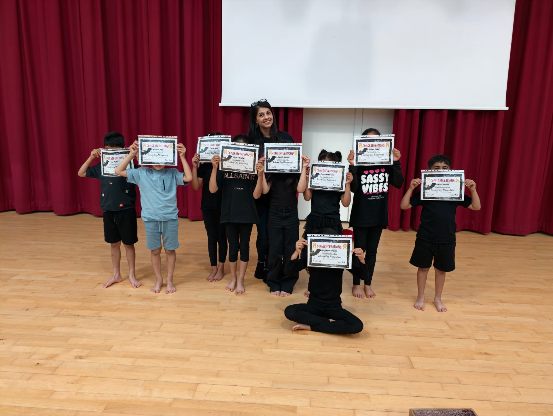 Children holding up their storytelling certificates