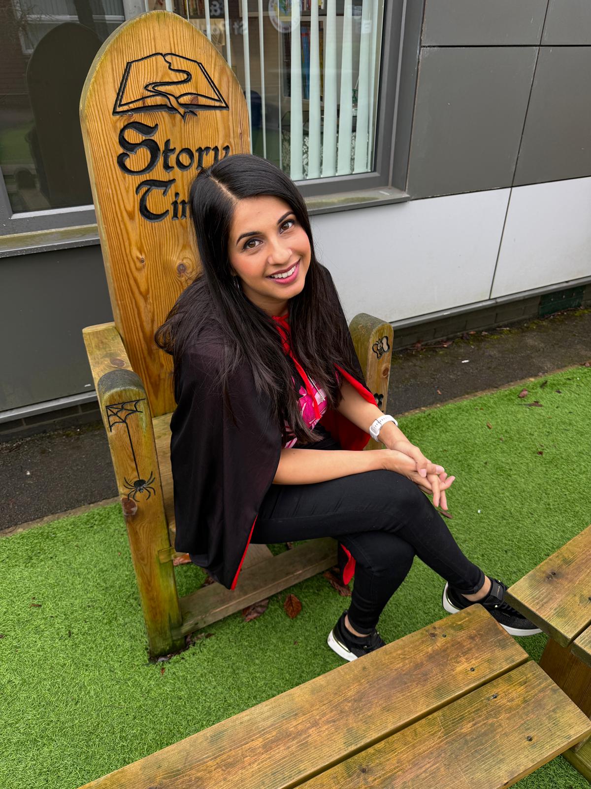 Saira Shah sitting in a school story time chair